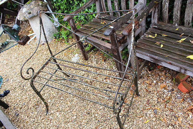 Appraisal: AN OLD BLACK PAINTED WROUGHT IRON BENCH with 'X' frame