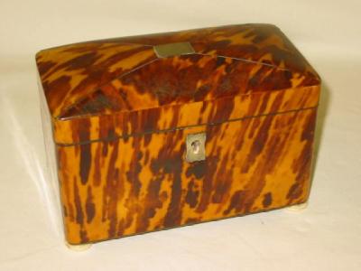 Appraisal: A TORTOISESHELL TEA CADDY of rounded oblong form the mildly