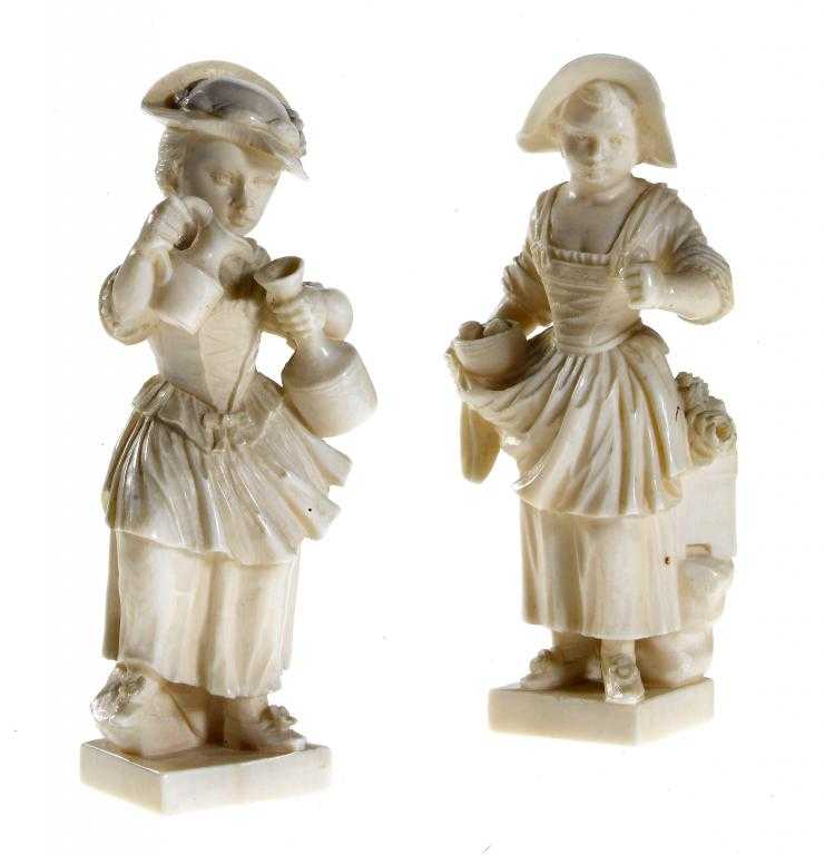 Appraisal: A PAIR OF NORTHERN EUROPEAN IVORY STATUETTES OF GIRLS one