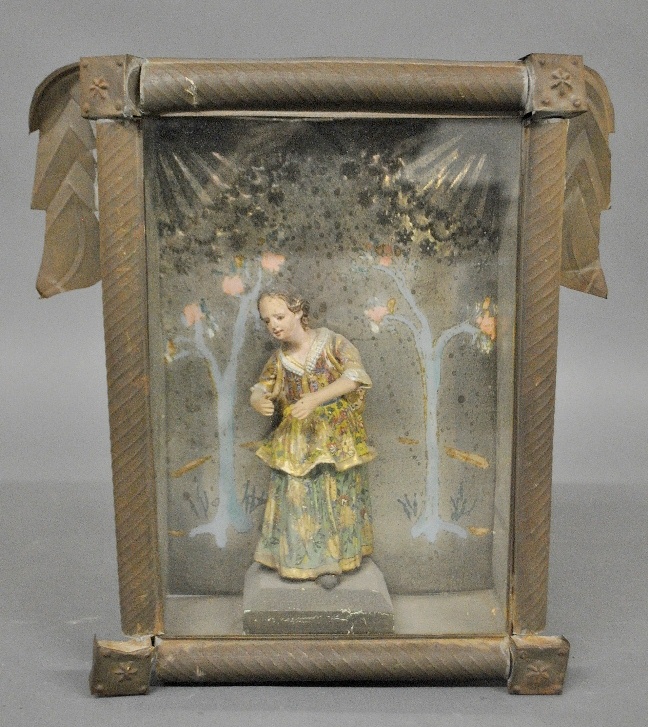 Appraisal: - Carving of a Mexican woman mounted in a tin