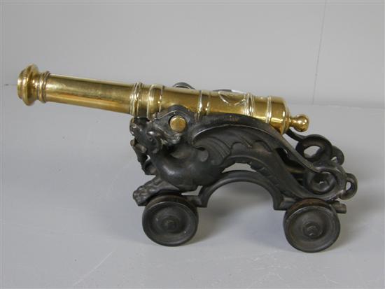 Appraisal: Bronze and cast metal table cannon the cannon stand cast