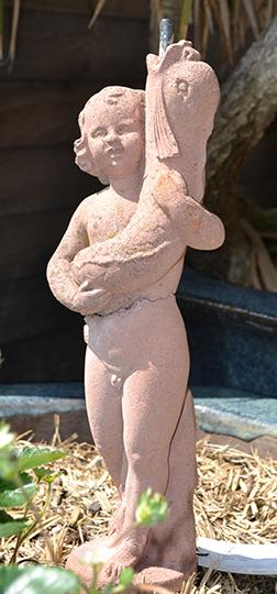 Appraisal: A SMALL COMPOSITE STONE FOUNTAIN HEAD OF A BOY HOLDING