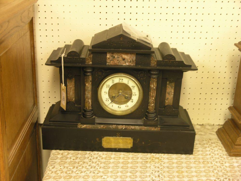 Appraisal: A Victorian black slate and marble mantel clock with enamelled