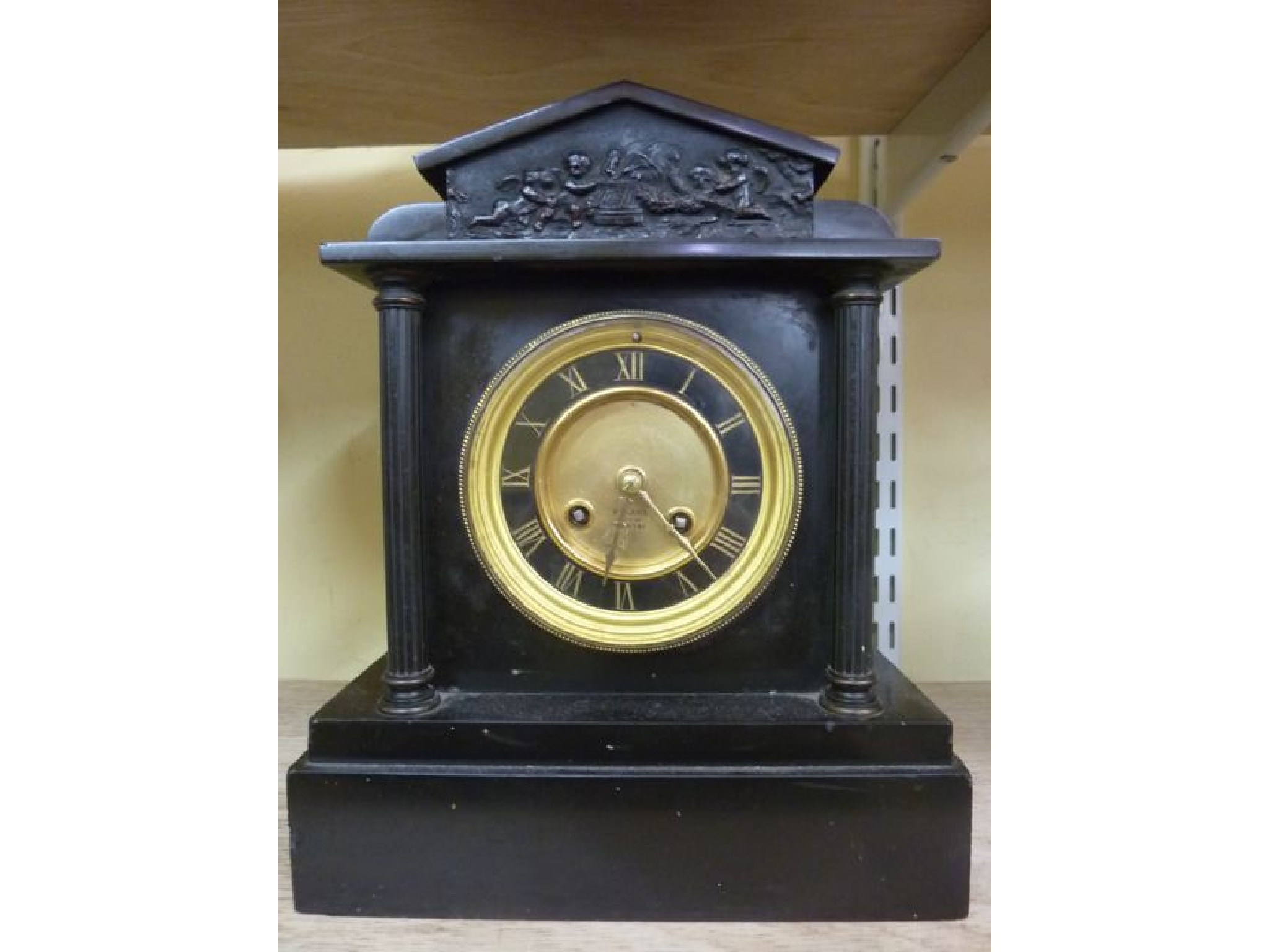 Appraisal: A Victorian black slate mantle clock in the classical style