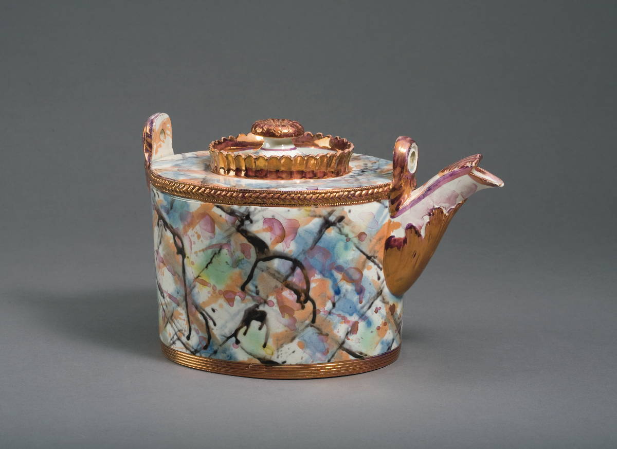 Appraisal: NEWCASTLE MARBLED LUSTRE OVAL TEAPOT AND COVER AND A TEAPOT