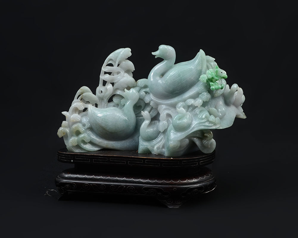 Appraisal: CHINESE CARVED JADEITE FAMILY OF SWANS Apple green and white