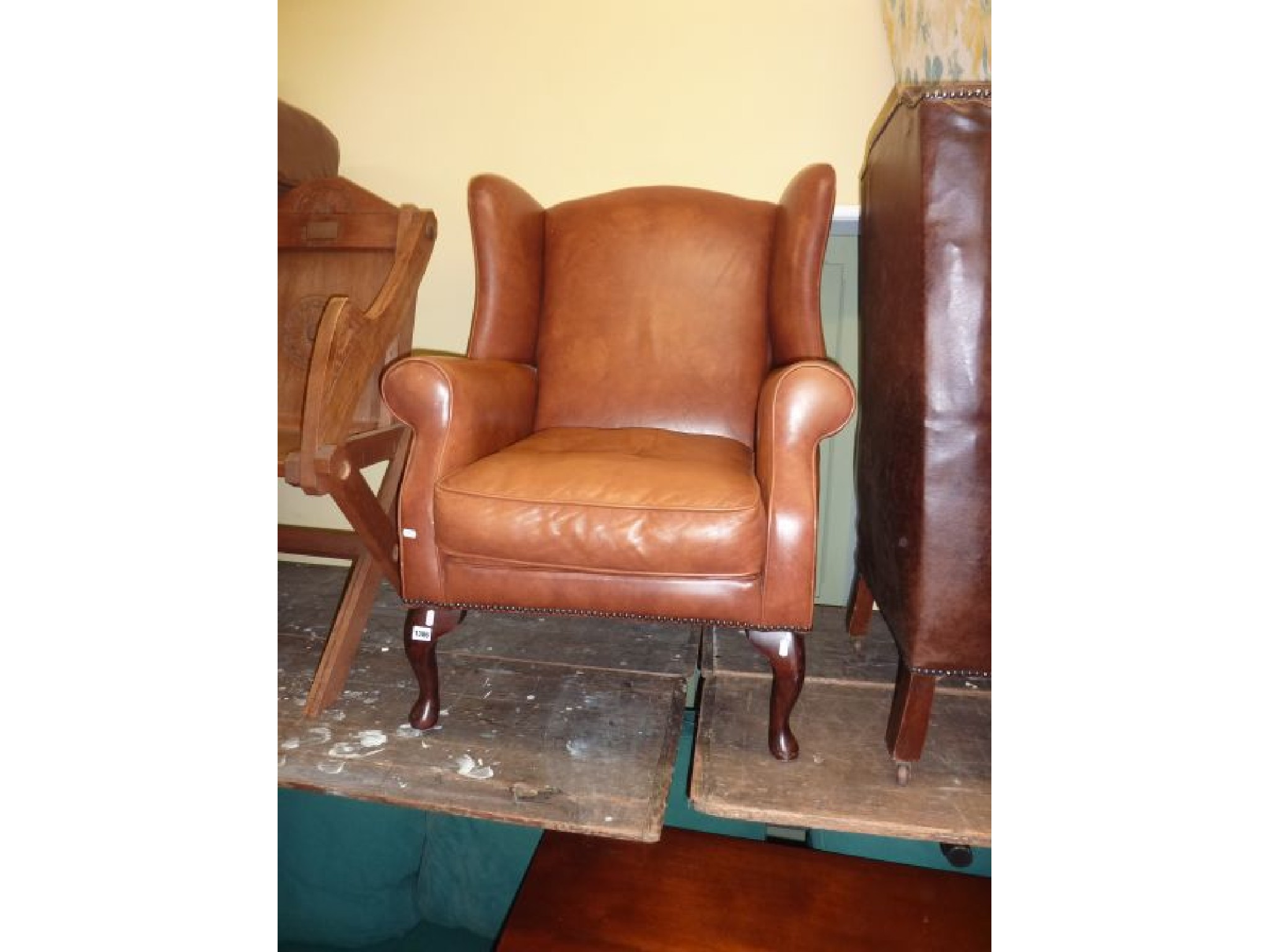 Appraisal: A Georgian style wing chair upholstered in a light tan