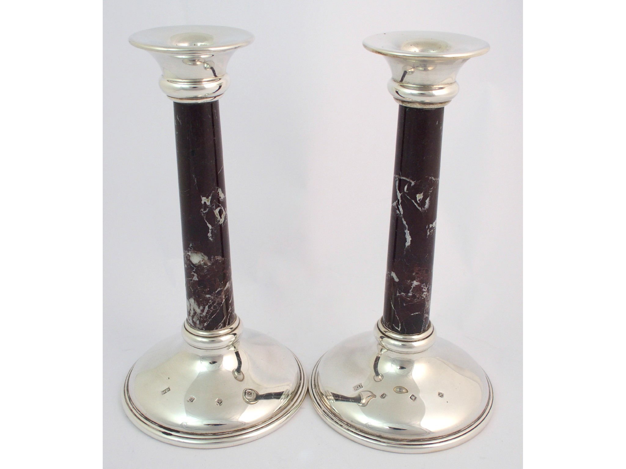 Appraisal: A pair of silver candlesticksby Hamilton Inches Edinburgh with flaring