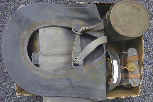 Appraisal: Grouping of gas masks leather leggings cartridge box and survival