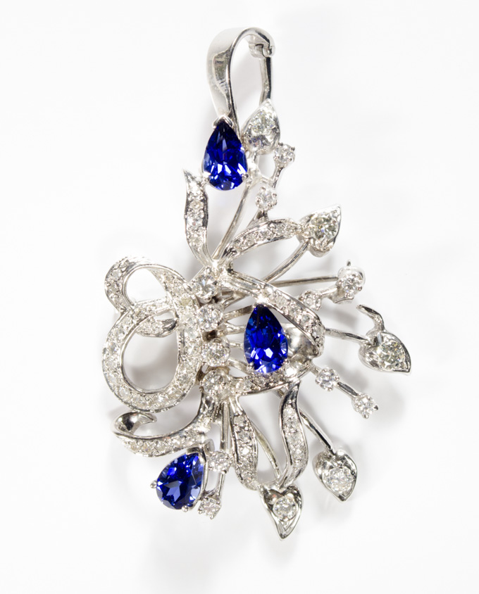 Appraisal: SAPPHIRE AND DIAMOND PENDANT BROOCH k white gold set with