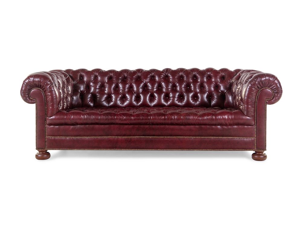 Appraisal: A Tufted Faux Leather Upholstered Chesterfield Sofa A Tufted Faux