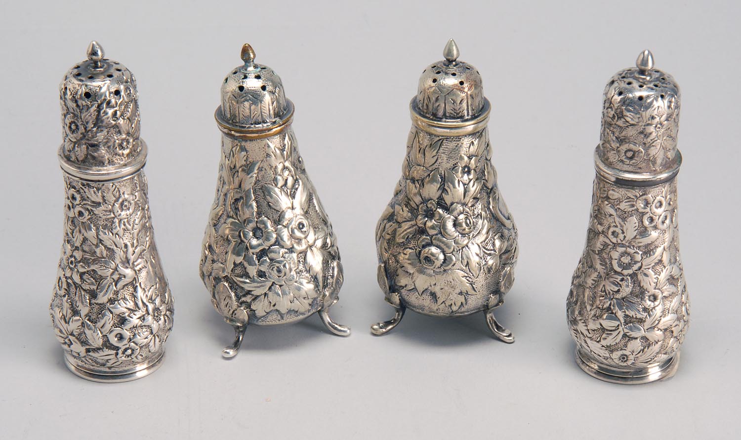 Appraisal: PAIR OF STERLING SILVER REPOUSS SALTS AND PEPPERS BY WELSH