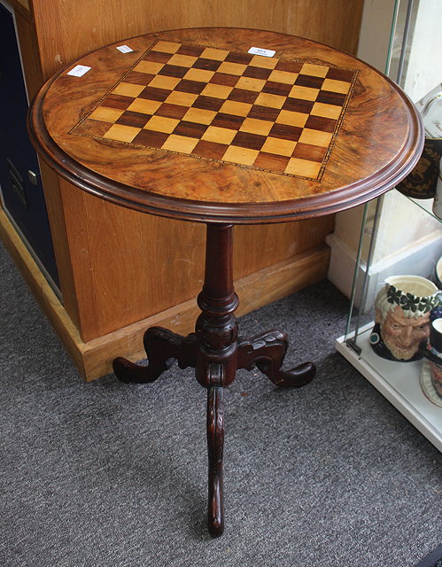 Appraisal: A VICTORIAN WALNUT AND TRIPOD GAMES TABLE a circular top