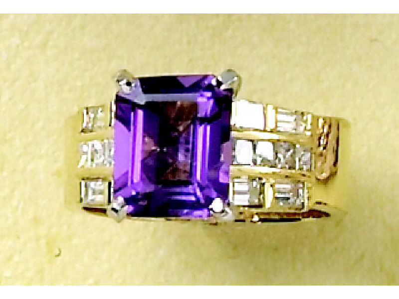 Appraisal: AMETHYST AND DIAMOND RING k yellow gold channel and bezel