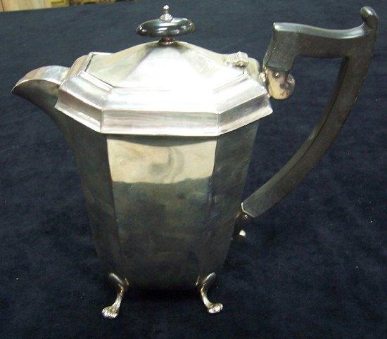 Appraisal: A hot water jug of octagonal form on scroll legs