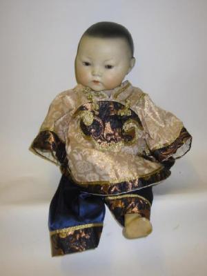 Appraisal: A German bisque head Oriental doll with brown sleeping eyes