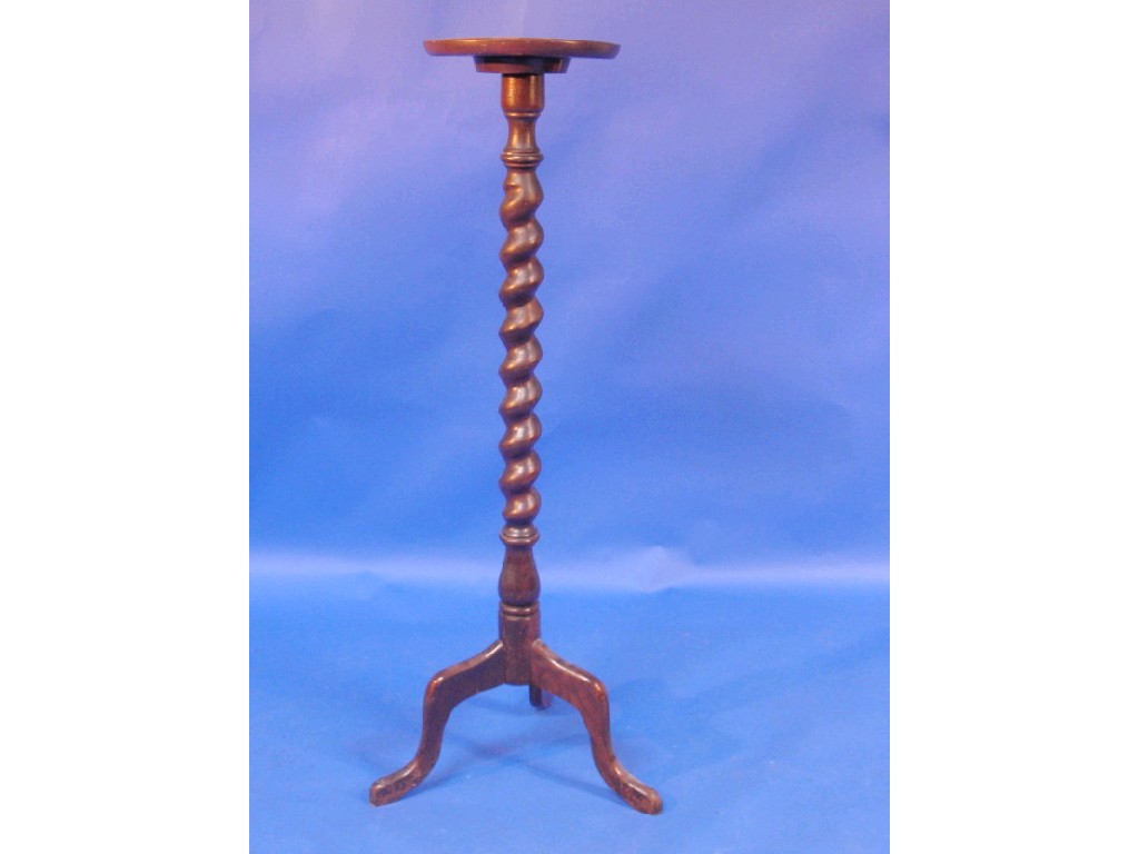 Appraisal: An oak torchere with spiral turned column and tripod base