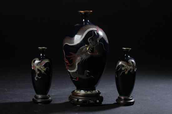 Appraisal: THREE JAPANESE CLOISONN ENAMEL DRAGON VASES Meiji period Each depicts