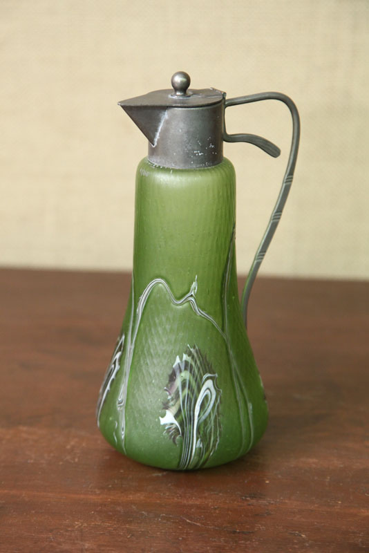 Appraisal: ART GLASS SYRUP PITCHER Attributed to Loetz Green textured body