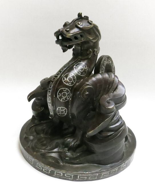 Appraisal: CHINESE BRONZE DRAGON SCULPTURE the stylized mythical creature in seated