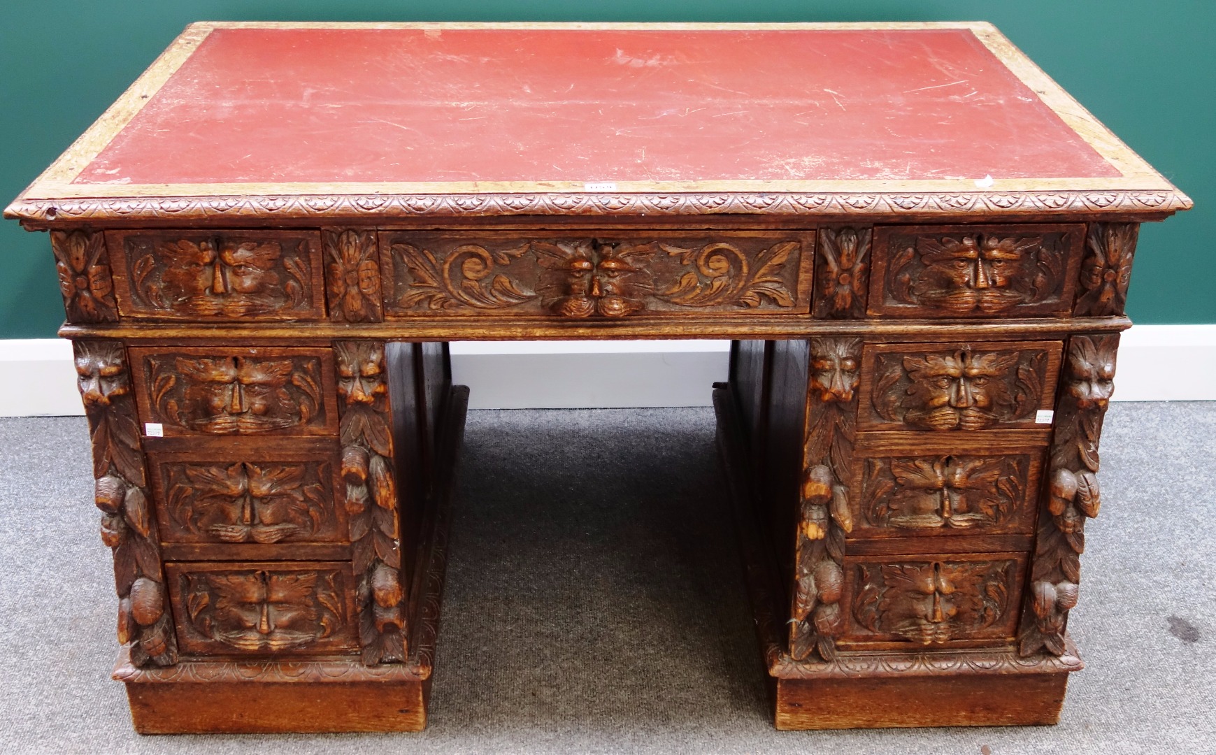 Appraisal: A th century carved oak writing desk with nine drawers