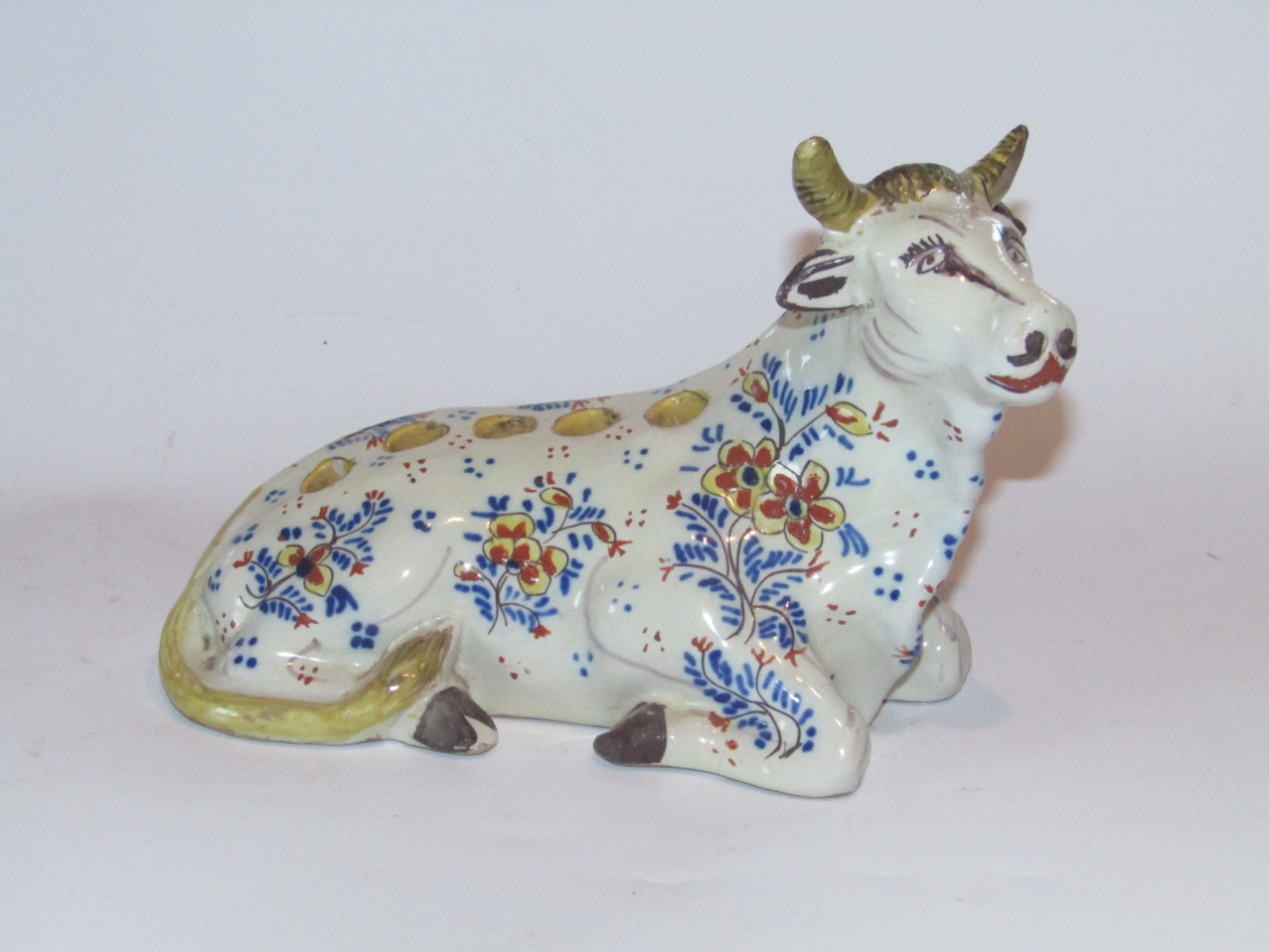 Appraisal: A Dutch Delft tin glazed earthenware recumbent cow flower brick