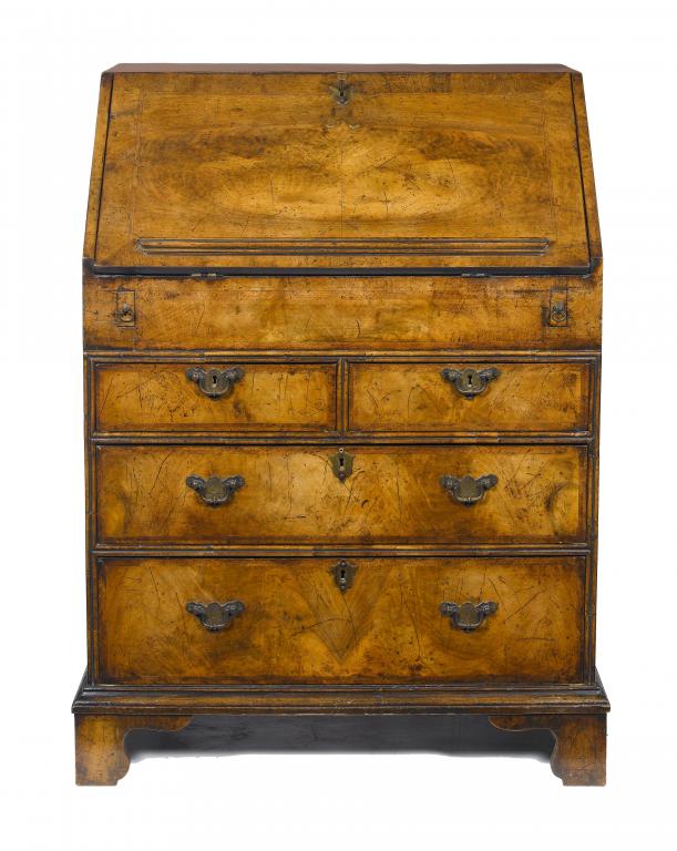 Appraisal: A WALNUT AND FEATHERBANDED BUREAU in matched veneers the stepped