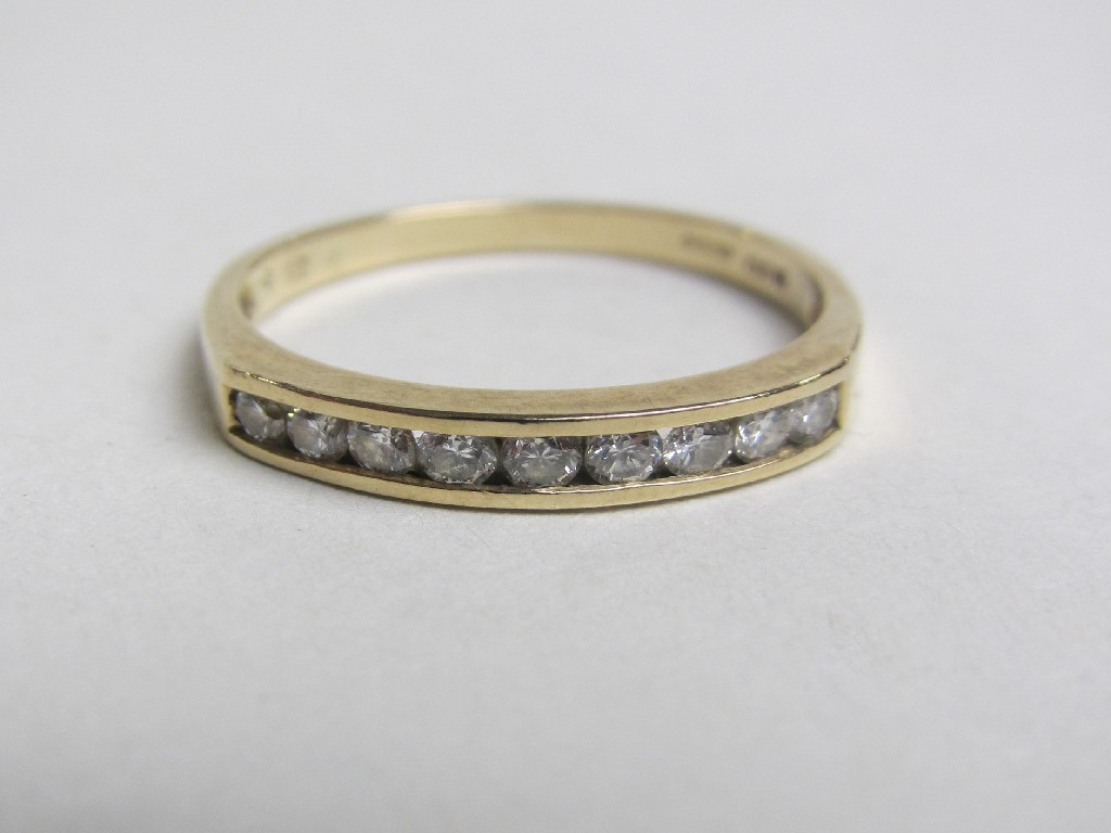 Appraisal: Nine carat gold channel set diamond half hoop ring