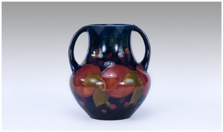 Appraisal: William Moorcroft Two Handled Vase Pomegranete and Berries Design Marks