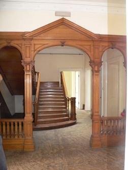 Appraisal: An oak architrave with triangular pediment set square pillar supports