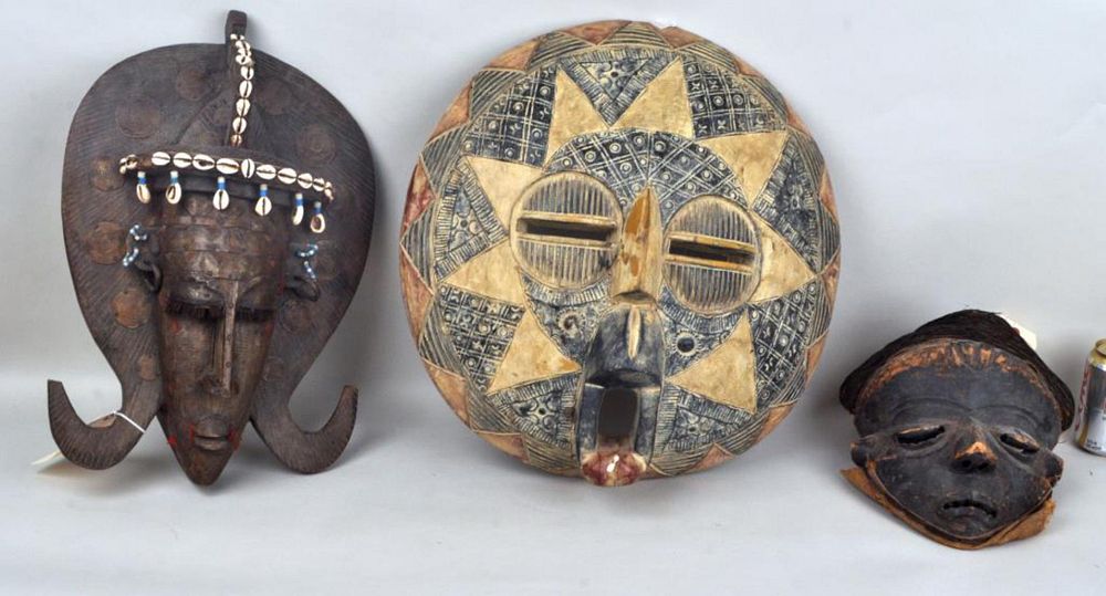 Appraisal: Group Three African Carved Wooden Masks the two larger embellished