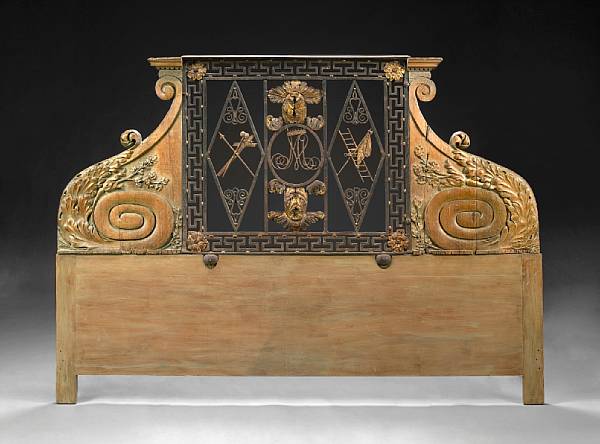 Appraisal: An Italian wrought iron and carved walnut headboard composed of