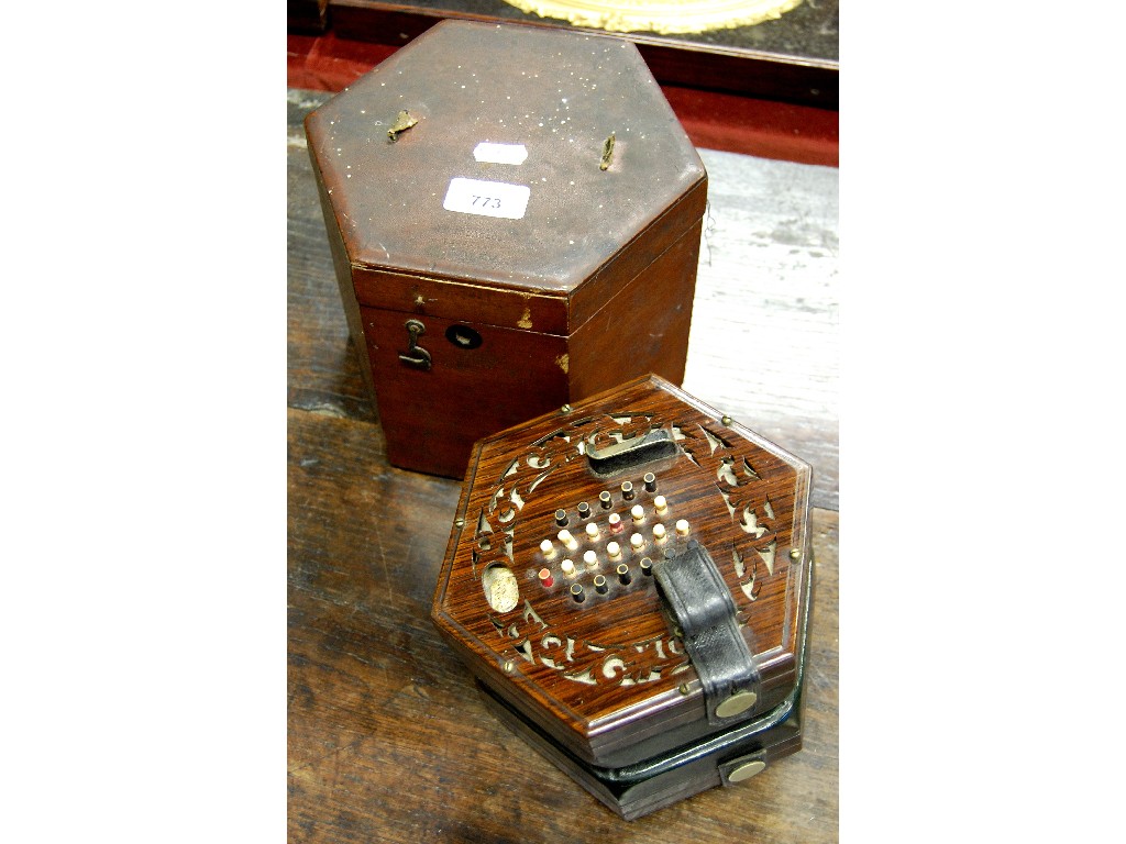 Appraisal: th century rosewood hexagonal concertina with fret-cut ends dyed ivory