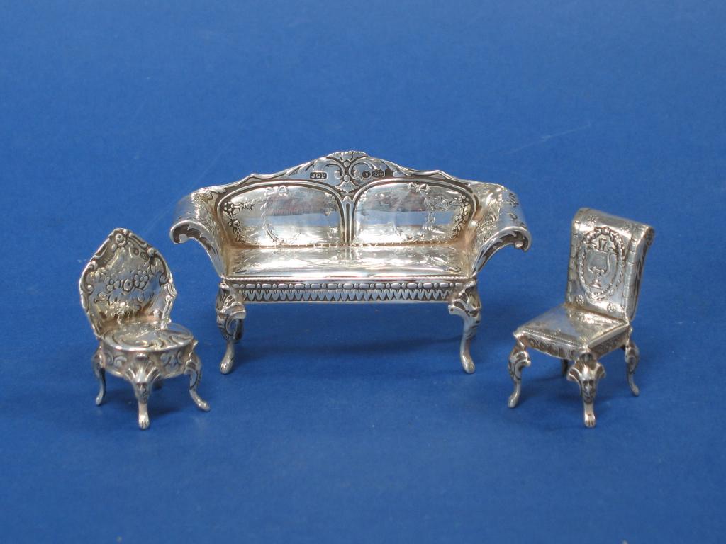 Appraisal: A CONTINENTAL MINIATURE MODEL OF A SETTEE and two salon