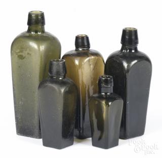 Appraisal: Five graduated olive glass bottles th th c '' -