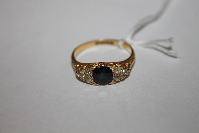 Appraisal: AN CT GOLD RING set with central sapphire flanked by