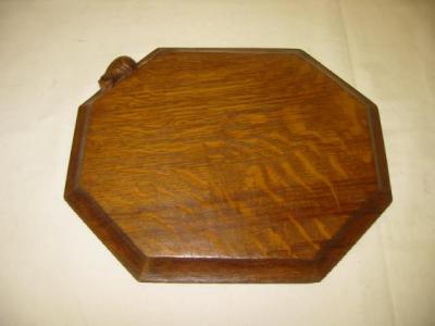 Appraisal: AN OAK BREADBOARD by Robert Mouseman Thompson of canted oblong