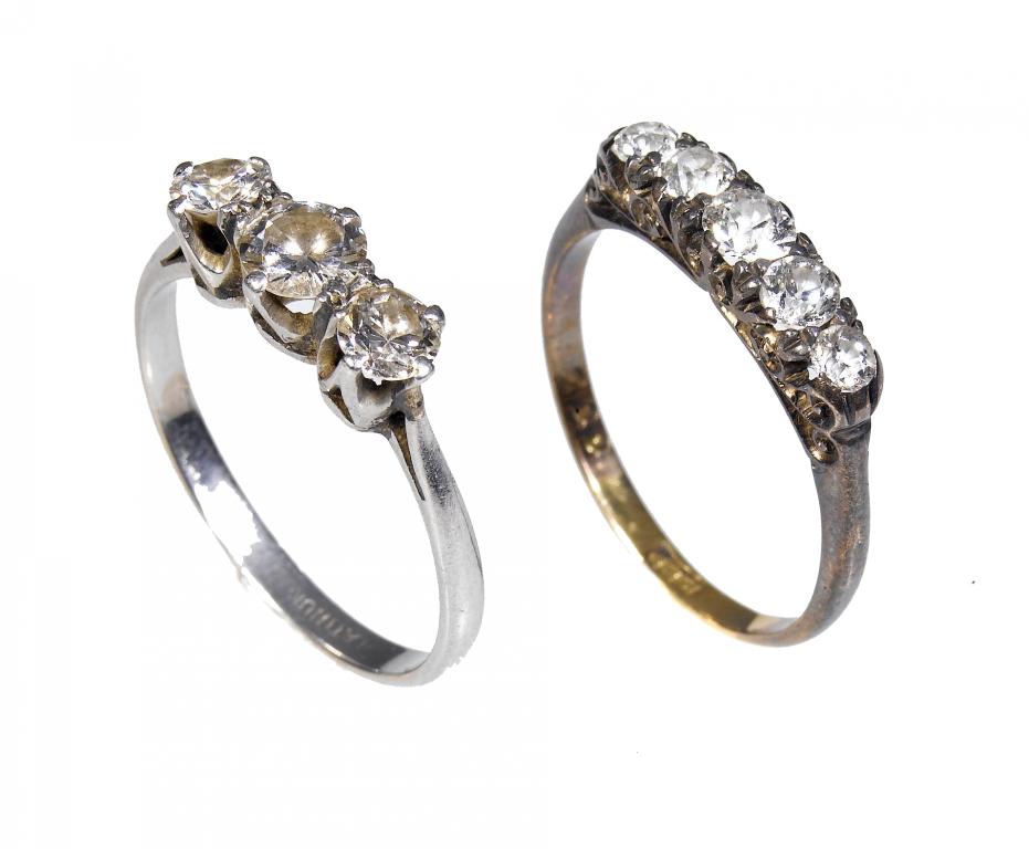 Appraisal: A DIAMOND THREE-STONE RING AND A DIAMOND FIVE-STONE RING the