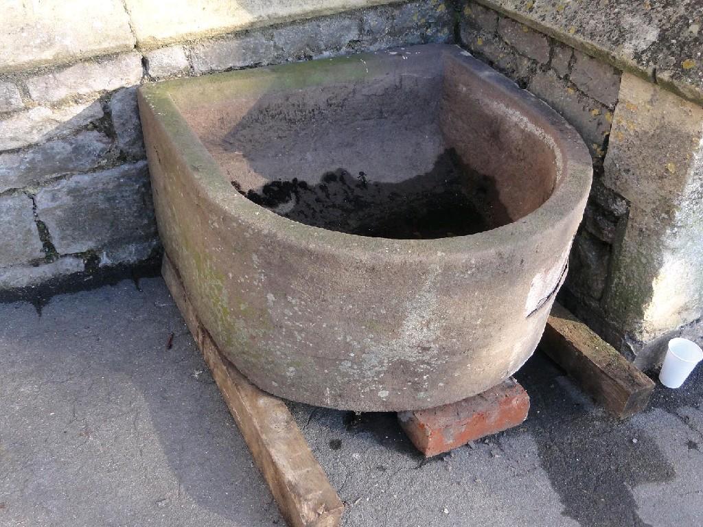 Appraisal: A weathered natural stone 'D' end garden trough thick walled