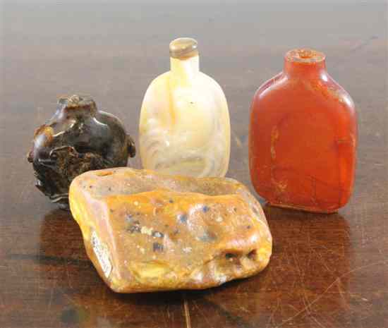 Appraisal: Three Chinese amber snuff bottles the first of plain flattened