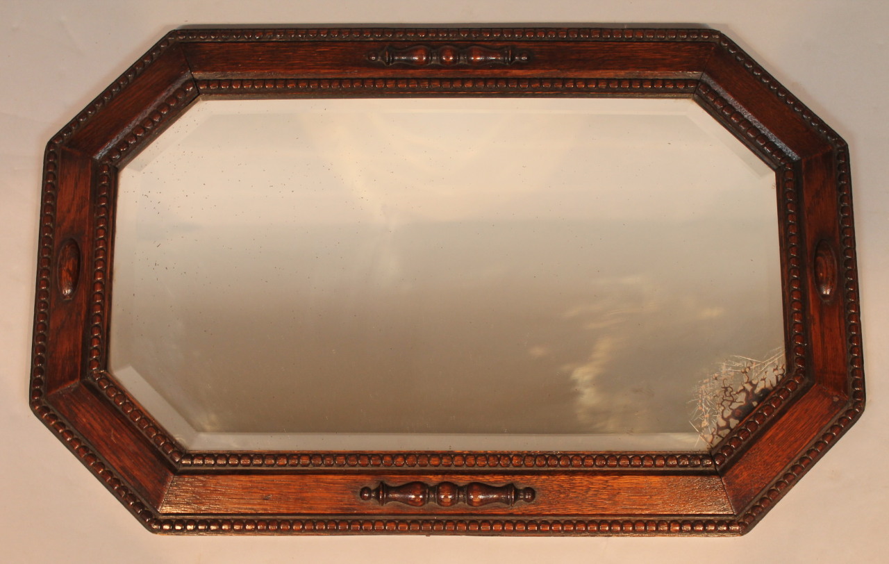 Appraisal: A 's oak framed wall mirror with octagonal outline and