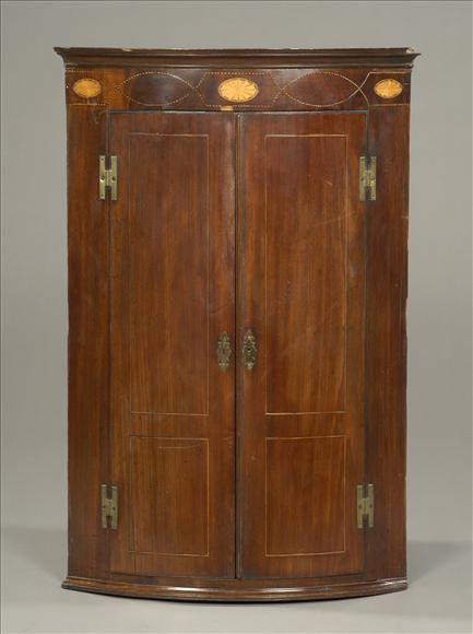 Appraisal: A George III mahogany bow front hanging corner cupboard circa