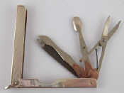 Appraisal: A silver folding etui containing three manicure implements and a