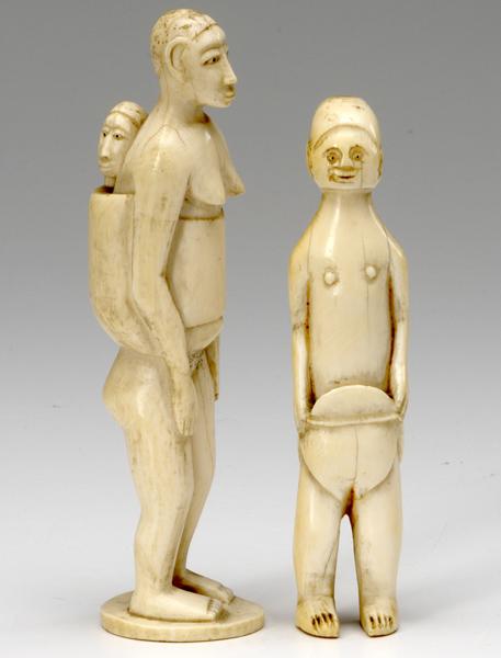 Appraisal: IVORY CARVINGS Figure of an African woman with baby in