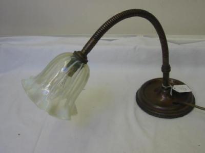 Appraisal: A VASELINE GLASS DESK LAMP with frilled shade on copper