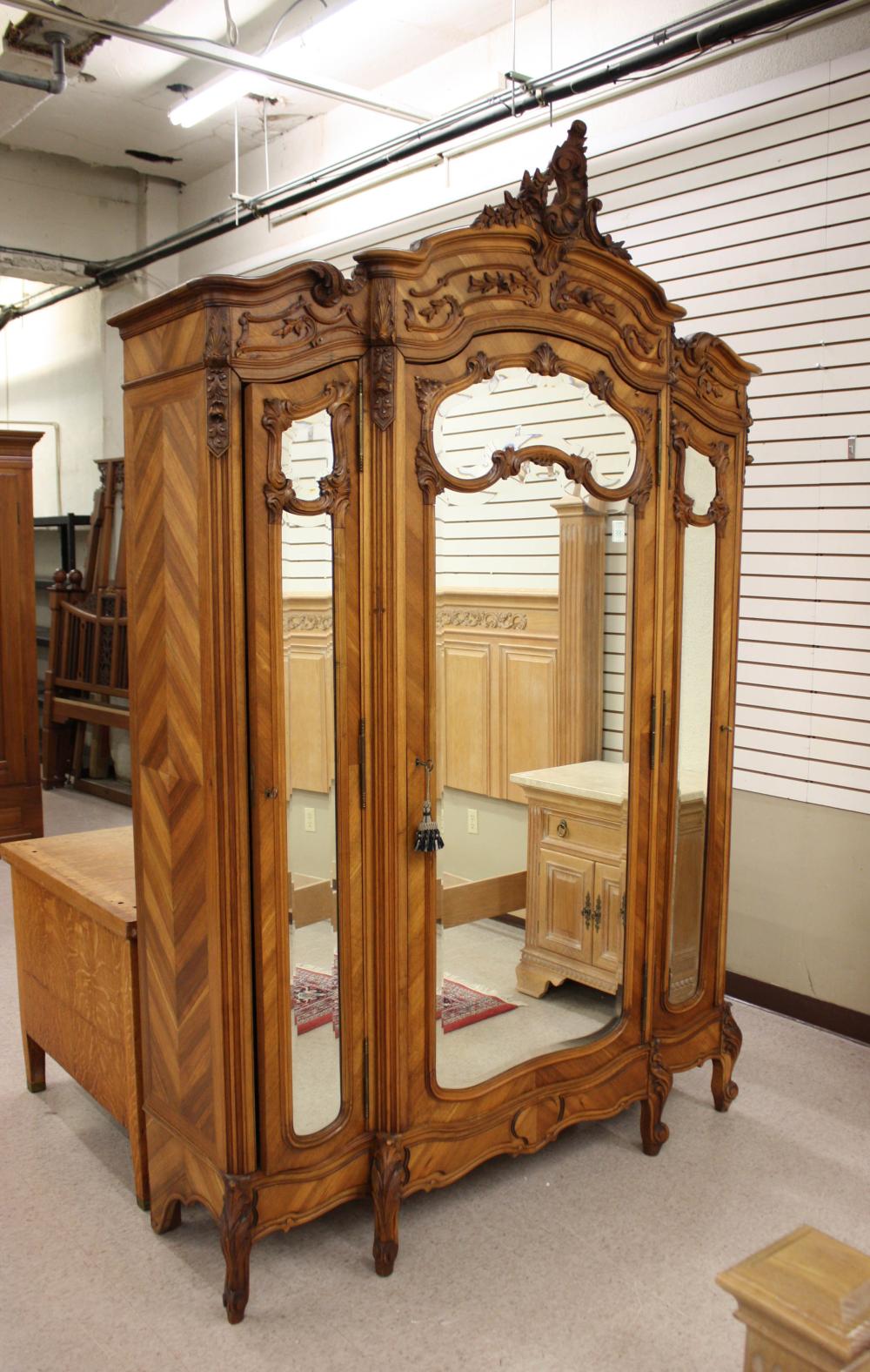 Appraisal: LOUIS XV STYLE THREE-DOOR WALNUT ARMOIRE French c the three