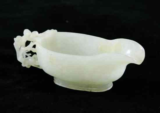 Appraisal: A Chinese pale celadon jade 'Yi' pouring vessel with openwork