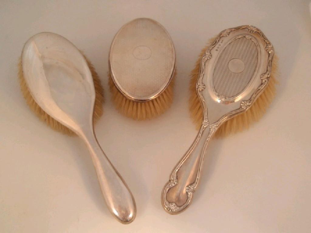 Appraisal: Three mixed silver dressing table brushes