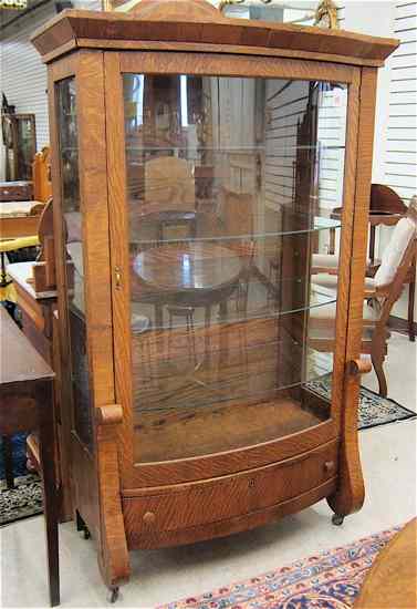 Appraisal: AN OAK AND CURVED GLASS CHINA DISPLAY CABINET Empire Revival