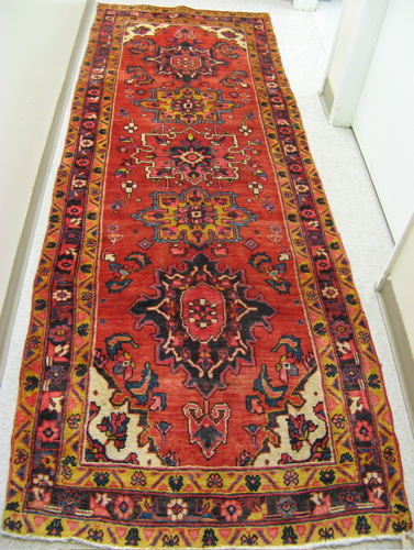 Appraisal: PERSIAN HALL CARPET Heriz district Azerbaijan province the red field